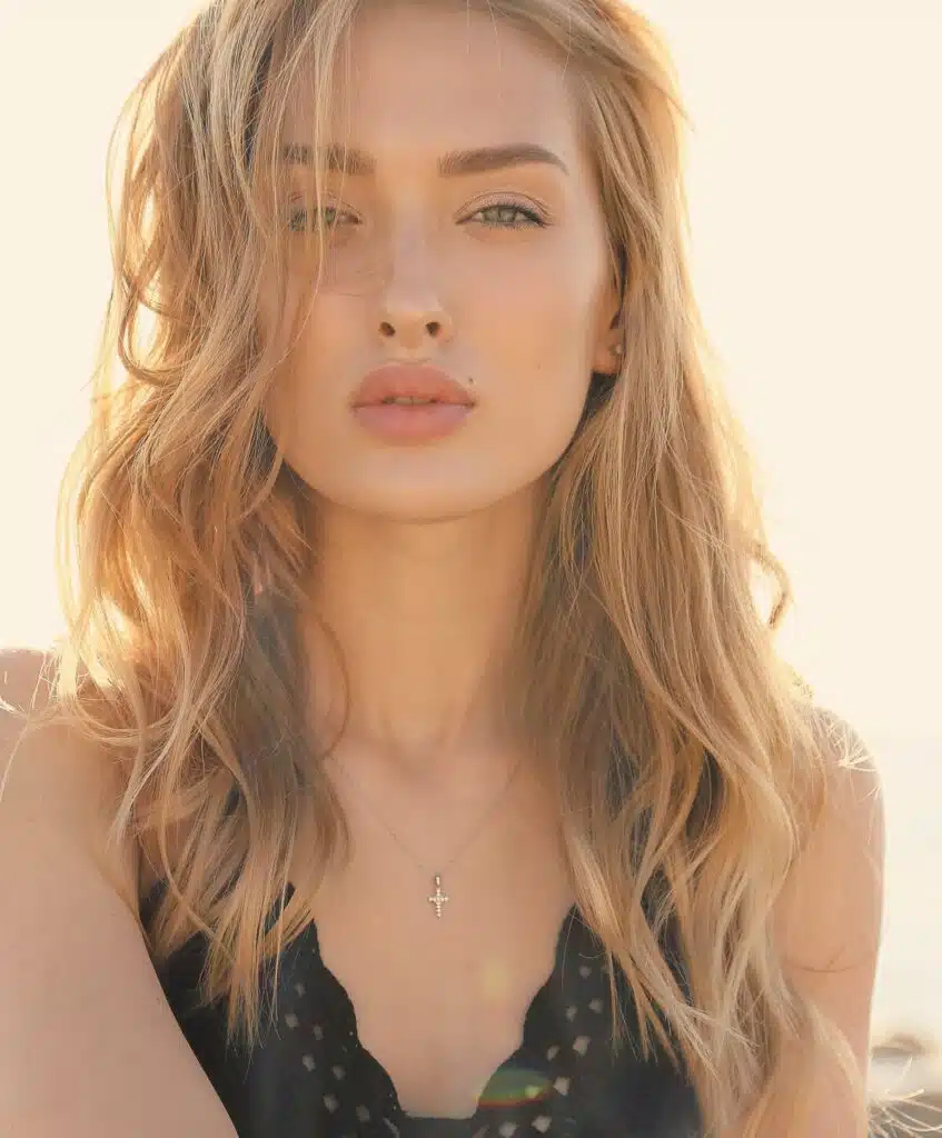 A Woman With Flawless, Glowing Skin, Embodying Natural Beauty And Confidence In A Sunlit Setting.