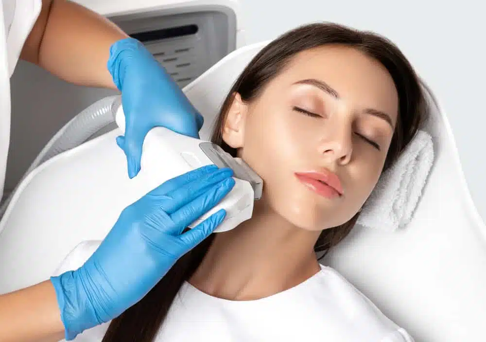 Woman-Receiving-Skin-Treatment-With-Laser-Device-On-Her-Neck-From-A-Therapist-Wearing-Blue-Gloves.